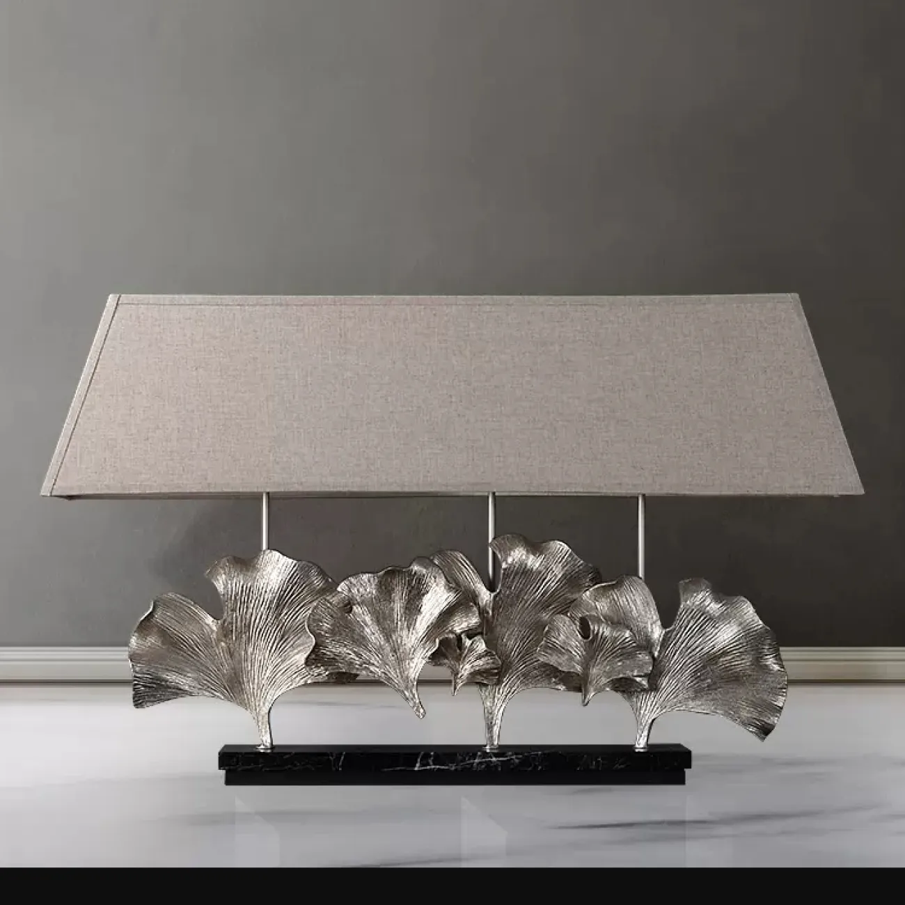 Серия настольных ламп с трапециевидным текстильным абажуром и декором в виде хромированных листьев гинкго на мраморном основании PHILOMENA L75