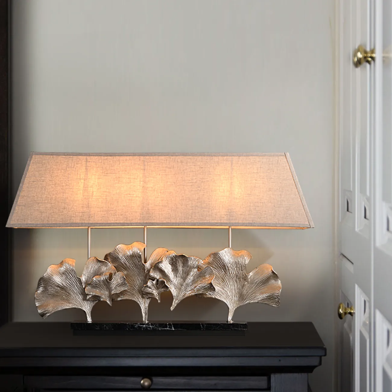 Серия настольных ламп с трапециевидным текстильным абажуром и декором в виде хромированных листьев гинкго на мраморном основании PHILOMENA L75