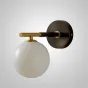 Серия настенных светильников с белым матовым плафоном шарообразной формы на черном кронштейне с латунной отделкой LOIS L1